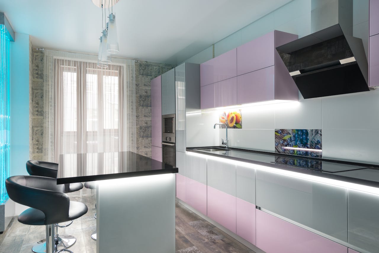 gallery-01 Stylish modern kitchen interior featuring glossy pink cabinets and a sleek design.